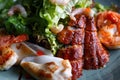 Seafood salad. Shrimps, eel, squids, lettuce. Against a dark background. Close up Royalty Free Stock Photo