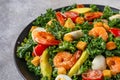 Seafood salad with shrimps, kale cabbage, avocado, tomatoes and quail eggsin a plate. Close up. Healthy diet food for Royalty Free Stock Photo