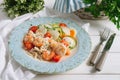 Seafood salad with vegetables. Shrimp, squid, with chopped cherry tomatoes, zucchini, carrots, daikon, grated cheese. Royalty Free Stock Photo