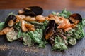 Warm salad with leaves, shrimp, mussels and sause