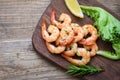 Seafood shelfish with rosemary lemon and lettuce - Salad shrimp grilled delicious seasoning spices on wooden cutting board Royalty Free Stock Photo