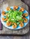 Seafood shrimp lettuce salad on blue plate Royalty Free Stock Photo