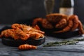 Seafood shrimp lie in plate, dark background. crab hairy, bottle of champagne and glass. Concept grilled dinner Royalty Free Stock Photo