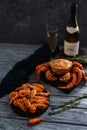 Seafood shrimp lie in plate, dark background. crab hairy, bottle of champagne and glass. Concept grilled dinner Royalty Free Stock Photo