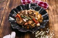 Seafood soba noodles wok in a black plate Royalty Free Stock Photo