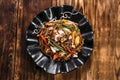 Seafood soba noodles wok in a black plate Royalty Free Stock Photo