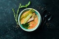 Seafood soup. Creamy tuna soup in a bowl on a black stone background. Top view. Rustic style Royalty Free Stock Photo