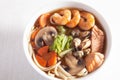 Seafood soup with noodles and mushrooms shrimp, salmon, mussels, carrots, lettuce