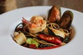 Seafood Spaghetti in white plate on wooden table