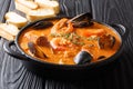 Seafood spicy soup with potatoes, shrimps, mussels, herbs and fi