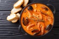 Seafood spicy soup with potatoes, shrimps, mussels, herbs and fi