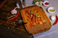 On a dark countertop, a light linen napkin, on a cutting board Seafood Squid in batter with sauce and spices on a board on a dark Royalty Free Stock Photo