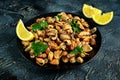 Seafood. Steamed Musseles appetizer with sprinkle of parsley and lemon juce served on black plate. Royalty Free Stock Photo