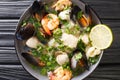 Seafood stew of shrimp, squid, mussels, fish, scallops in wine sauce close-up in a bowl. horizontal top view Royalty Free Stock Photo