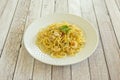 Seafood-style spaghetti with sautÃÂ©ed prawns, cayenne and raw parsley on a white plate