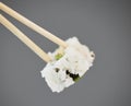 Seafood, sushi and chopsticks on studio background, California roll with seaweed for healthy Asian dining promo Royalty Free Stock Photo