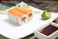 Seafood sushi rolls in white plate with chopsticks and japanese spices Royalty Free Stock Photo