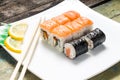 Seafood sushi rolls in white plate with chopsticks and spices Royalty Free Stock Photo