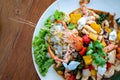 Seafood Thai mixxed together between boiled shrimp, crab, squid and colourful vegetable in dish on wood table in restaurant