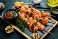 Seafood. Tiger prawns. Shrimp fried in skewers. On a stone background. Royalty Free Stock Photo