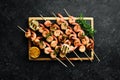 Seafood. Tiger prawns. Shrimp fried in skewers. On a stone background. Royalty Free Stock Photo