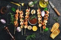 Seafood. Tiger prawns. Shrimp fried in skewers. On a stone background. Royalty Free Stock Photo