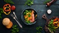 Seafood with vegetables. Boiled vegetables with shrimp and mussels. In a black plate. Top view. Royalty Free Stock Photo