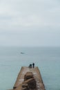 Seaford, East Sussex | UK -  2021.04.04: Men fishing early morning at the Seven Sisters West beach side Royalty Free Stock Photo