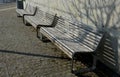 Seafront with plane trees growing out of the lattice in the pavement. a beige concrete staircase serves as a theater bench overloo