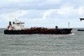 Seagoing vessels sailing past cause waves on the quays