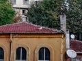 A seagull and a crow stand on the red tile roof of an old building in Istanbul Turkey