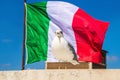 Seagull patriot, behind waving the Italian flag. Seagull standing with Italy flag on background.