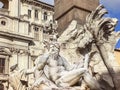 A seagull resting on the head of the statue representing the Ganges river in the Fountain of the four rivers in Piazza Navona in Royalty Free Stock Photo