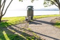 Seagull scavenging rubbish from overflowing trash bin Royalty Free Stock Photo