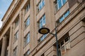 The seagull sits on a street light pole, next to a historic building in Liverpool, Royalty Free Stock Photo