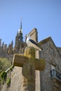 Seagull sitting on cross of Cathedral in Mont Saint Michel, Normandy, Northern France, Europe