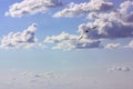 Seagull soaring in clouds in blue sky in sunny summer day. Seashore, ocean shore Royalty Free Stock Photo