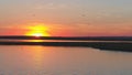 Seagulls bird fly above the river at sunset time. Birds fly at sunset. Sunset on the river, aerial Royalty Free Stock Photo