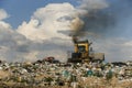 Seagulls fly over piles of garbage. A bulldozer tractor works at a large landfill near Kyiv, Ukraine. May 2016