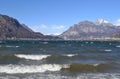 Seagulls are flying over the stormy lake Garlate. Royalty Free Stock Photo