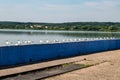 Seagulls are sitting on pier on shore of large lake Royalty Free Stock Photo