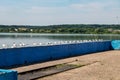 Seagulls are sitting on pier on shore of large lake Royalty Free Stock Photo