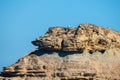 Seagulls sitting on top of a cliff against a blue sky with white clouds Royalty Free Stock Photo