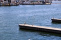 Seagulls standing on the docks near White boats and yachts at the docked in the harbor with deep blue ocean water and blue sky Royalty Free Stock Photo