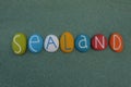Sealand, souvenir with multicolored stone letters over green sand Royalty Free Stock Photo