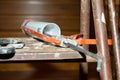 a sealant gun and a spatula on an old ladder at home