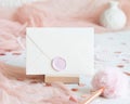 Sealed envelope near pink decorations, hearts and tulle on white table close up, mockup