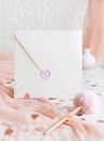 Sealed envelope near pink decorations, hearts and tulle on white table close up, mockup Royalty Free Stock Photo