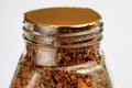 Sealed glass jar filled with instant coffee granules against a light background Royalty Free Stock Photo