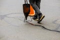 Sealing joint crack in asphalt road surface restoration work Royalty Free Stock Photo